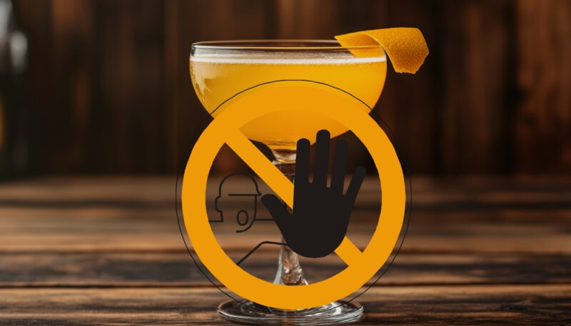 A cocktail glass with a prohibition symbol overlay, emphasizing avoidance after tooth extraction